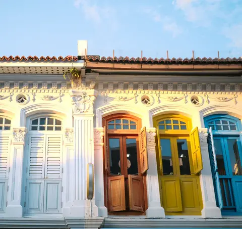 Restored Chinatown shophouses with blue, yellow and timber doors