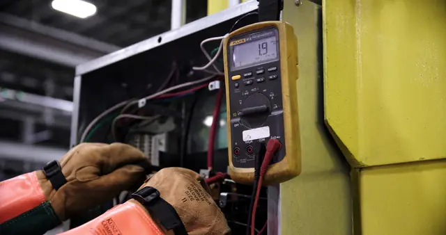 Technician testing a distribution panel