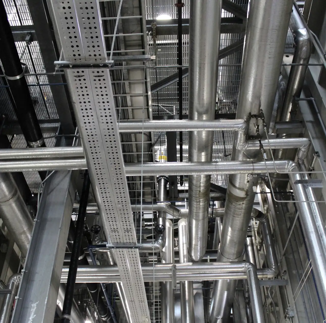 Plant room ceiling with new stainless steel pipework, cable trays and ventilation ducts