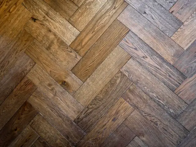 Close-up of a warm oak herringbone floor