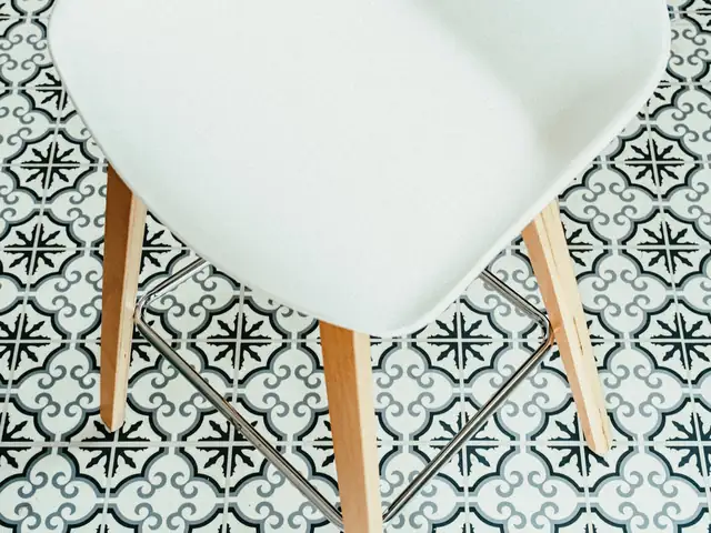White stool on a black-and-white patterned tile floor