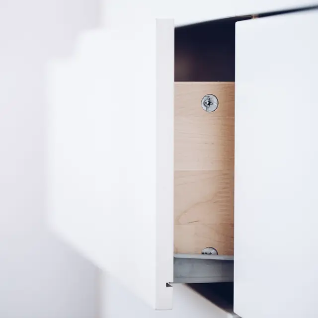 Close view of a half-open drawer on its metal runner