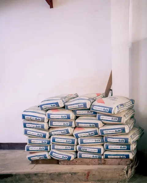 Bags of cement stacked on a wooden pallet