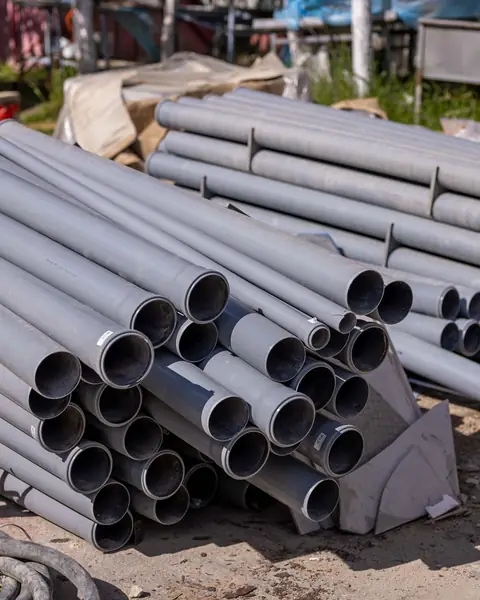 Grey uPVC pipes piled on a building site
