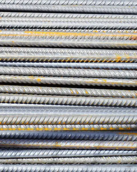 Ribbed steel reinforcing bars stacked side by side