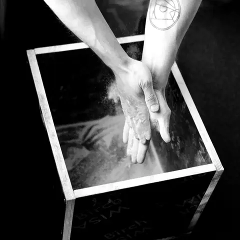 Chalked hands over the chalk box