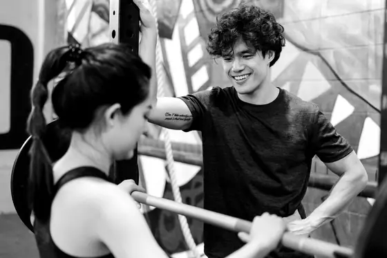 Joel laughing with a member between sets