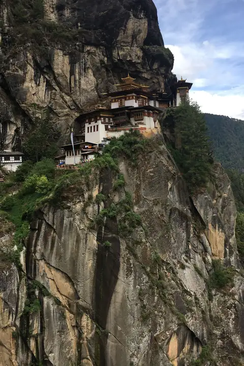 Taktsang, the Tiger's Nest monastery, clinging to a cliff above pine forest in Paro, Bhutan