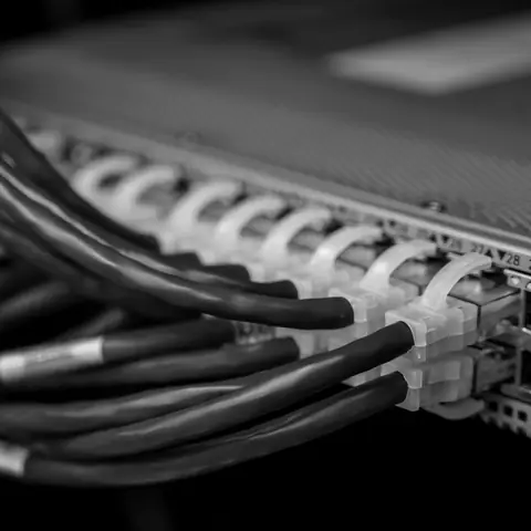 Cat6 cables plugged into a network switch, close up